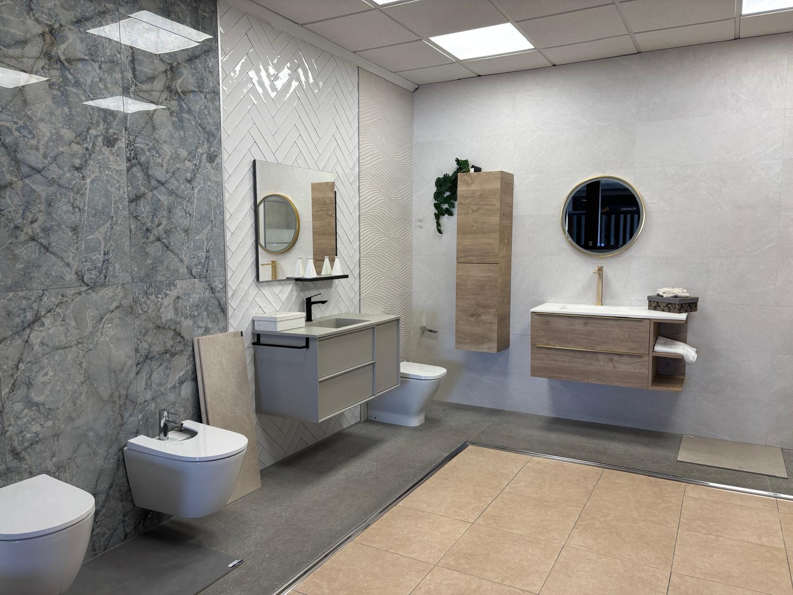 Baño de exposición con mueble en tonos madera y grifería dorada